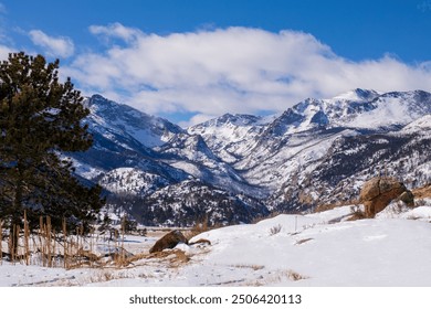 Snow in the high country in the Colorado Rockies.  Trees and snow in the foreground of the mountains of Colorado.  Pockets of snow and drifts in Moraine Valley. Rocky Mountain Natl Park. Blue sky. - Powered by Shutterstock