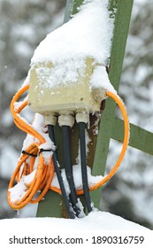 Snow And Ice Covered Socket And Cables. Snow-covered Electrical Cables. Outdoor Socket