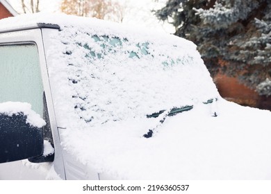 Snow And Ice Covering A Car Windscreen Or Windshield, Parked On A Driveway Outside A House, UK