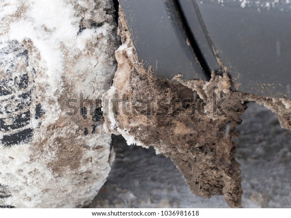 ,snow and ice dirty adhered to the car in the winter\
season. Photo close up