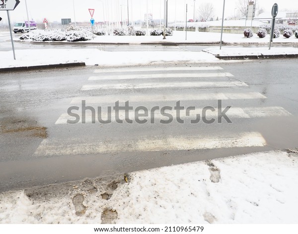 Snow, ice, slush and winter mud at a pedestrian\
crossing. The air temperature is about 0. Difficult driving\
conditions. Braking distance of the car. Traffic Laws.\
Infrastructure and road\
services.