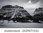 Snow ladnscape in swiss alps with lodge and mountain panorama