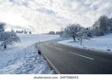 Snow landscape with trees, road and blue sky with clouds - Powered by Shutterstock