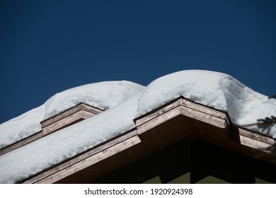 Snow Layered On Exterior Rooftop Of Urban House Or Ski Chalet In Ski Village Cold Winter Temperatures With Good Snow Fall Horizontal Format 