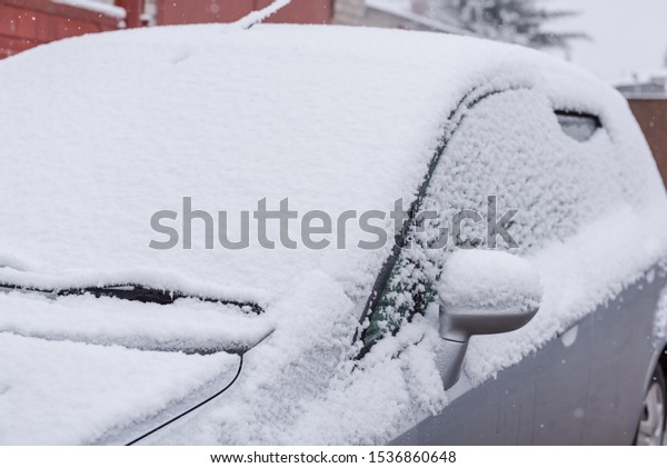 Snow lies on a car. Snow. White snow flakes.\
Cold weather. Snow on a car\
close-up
