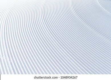 Snow lines made by a snow machine or snowcat on a ski slope in Bavaria, Germany.