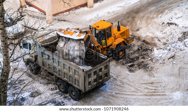 Snow loading by road machinery after heavy snowfall\
in residential block