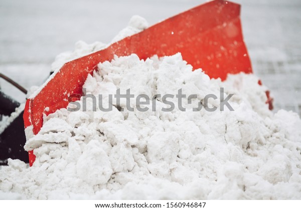 Snow machine cleans\
the snow in the city\
