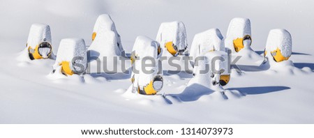Snow making machine turned of and covered with lot of snowy close up. Snowguns or cannon not working panorama.