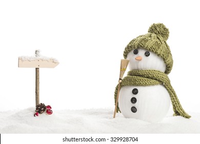 snow man with a sign in a artificial winter landscape