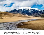 As the snow melts in the nearby Sangre de Cristo mountain range, Medano Creek begins to flow in front of the Great Sand Dunes National Park and Preserve in early spring.