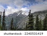 Snow and mist covered rocky mountains in Alaskan range