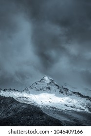 The snow mountain under the dark clouds