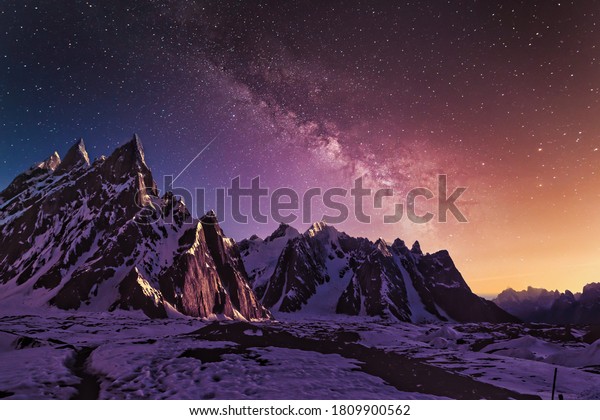 Snow mountains with dramatic starry evening galaxy Beautiful Purple and yellow wallpaper.
