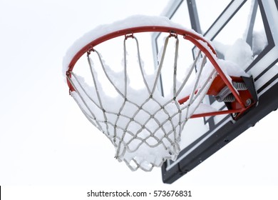 Snow On A Basketball Hoop Outdoors In Winter