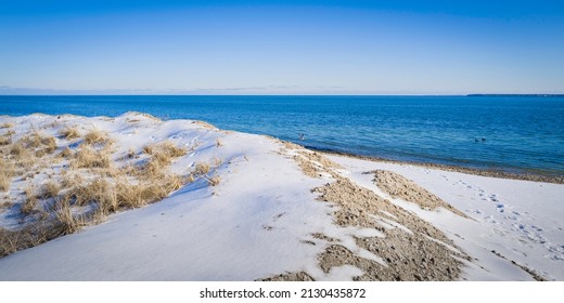 Snow On The Beach. Winter Seascape Over The Erosion Control Sand Piles On Cape Cod. 