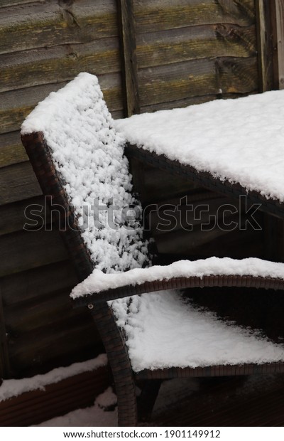 Snow on garden\
patio furniture winter scene\
