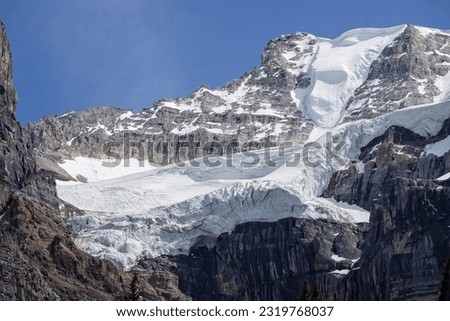 Snow on glacier shaped like giant face at Lake Moraine, Banff National Park, Canadian Rockies, Alberta, Canada on 5 June 2023