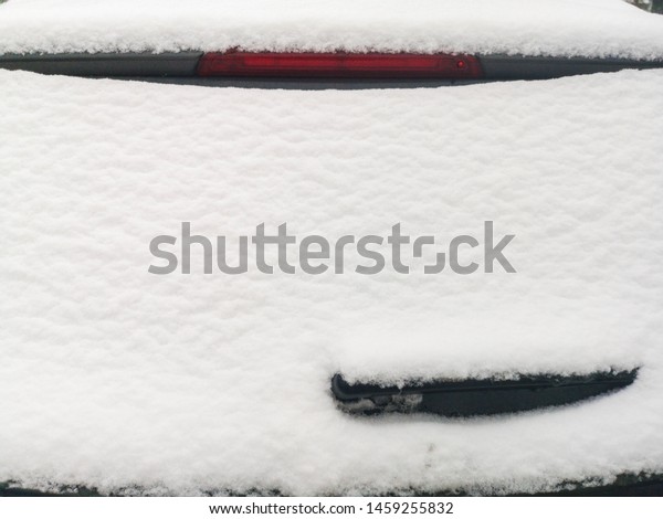 Snow on the rear window of the car. ar rear window\
in the snow