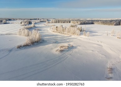 The Snow On The River Ice Is Decorated With Snow Mobile Tracks. The Frozen River Is An Excellent Track For High Speed Snow Mobile Racing.