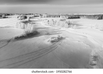 The Snow On The River Ice Is Decorated With Snow Mobile Tracks. The Frozen River Is An Excellent Track For High Speed Snow Mobile Racing.