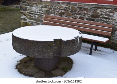 Snow On A Round Stone Table