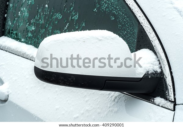 snow on side window of\
the white car
