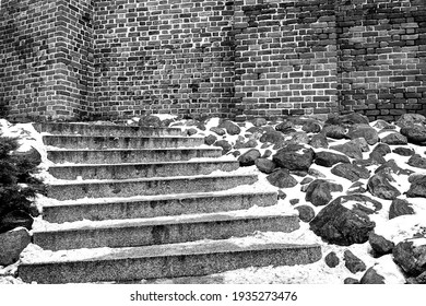 Snow On Stone Steps And A Medieval Brick Wall In Poznan, Monochrome
