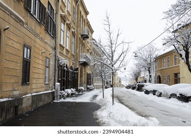  Snow on the street in the city. Sibiu during a winter day. Romania  - Shutterstock ID 2394904481