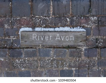 Snow on Top of a Sign for the River Avon in Stratford upon Avon, Warwickshire, England, UK