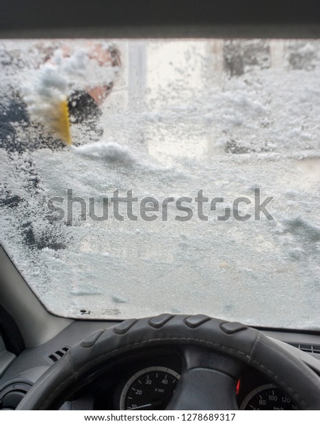 snow on windshield, snow cleaning, car in\
winter conditions