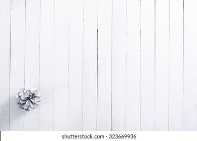 snow painted pine cone on rustic white wood table, Christmas decoration background - Powered by Shutterstock