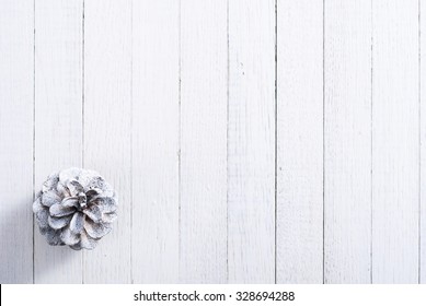 snow painted pine cones on rustic white wood table, Christmas decoration background - Powered by Shutterstock