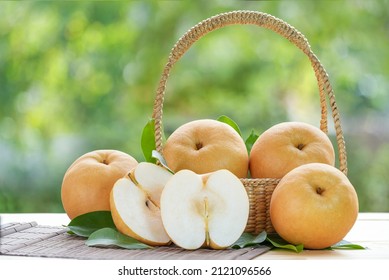 Snow pear fruit in wooden basket, Fresh Nashi pear or Korean pear fruit in the basket over green natural Blur background. - Powered by Shutterstock