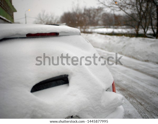 Snow pile on\
the car top, outdoor cropped\
image