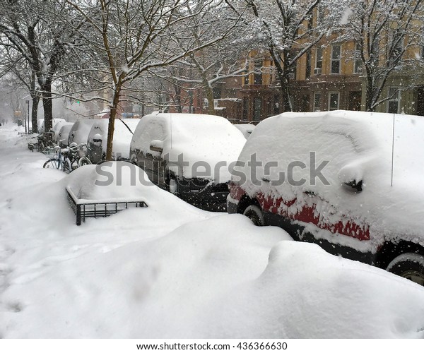Snow piled up on the sidewalk and cars in Park\
Slope, Brooklyn