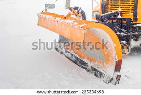 Snow plow doing snow removal after a blizzard in Chicago suberb.
