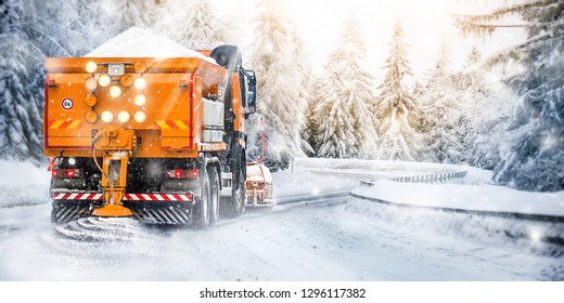 Snow Plow On Highway Salting Road . Orange Truck Deicing Street. Maintenance Winter Gritter Vehicle Wide Panorama Or Banner.