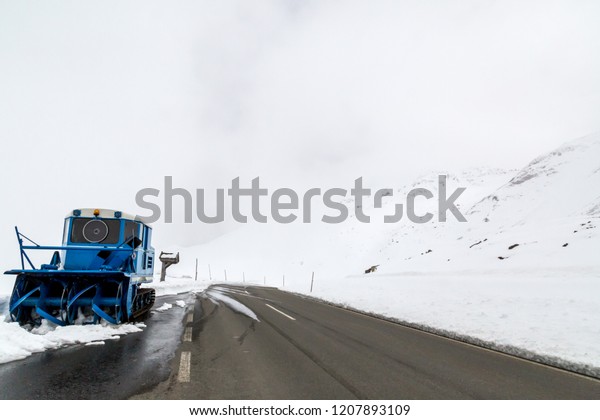 a snow\
plow is ready to clear the road from\
snow
