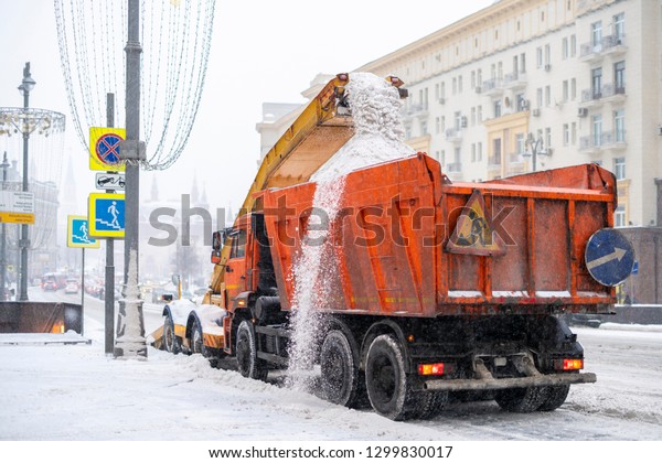 snow plow removing snow\
from the road