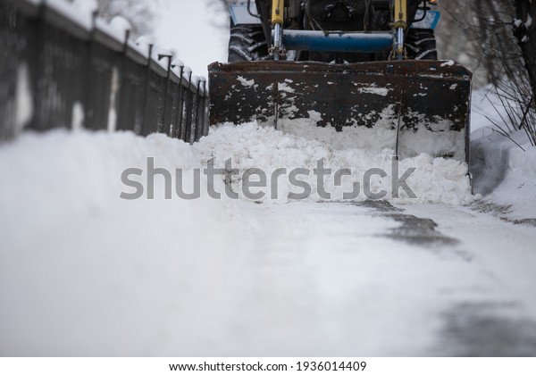 Snow plow
and snow truck cleaning the streets during a snow storm in night
maintenance action in Belgrade,
Serbia