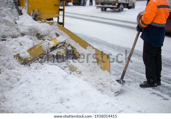 Snow plow\
and snow truck cleaning the streets during a snow storm in night\
maintenance action in Belgrade,\
Serbia