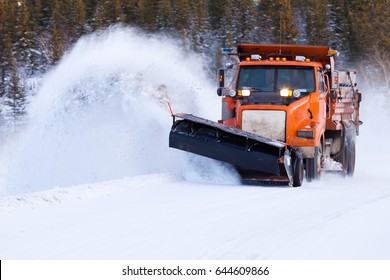 Snow Plow Truck Clearing Road After Winter Snowstorm Blizzard For Vehicle Access