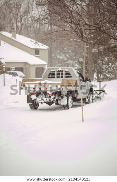 Snow plow truck working\
on a snow day