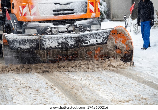 Snow plow trucks cleaning the snow from road.\
Winter snow removal\
concept.\
