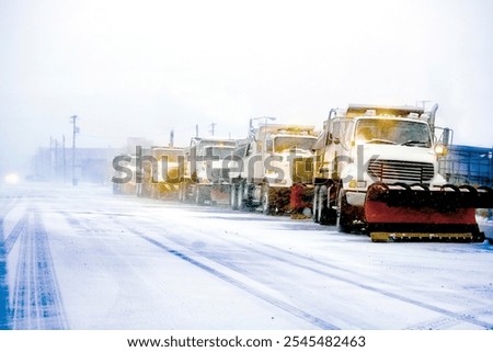 Snow plows in severe blizzard preparing for storm clearing street driving