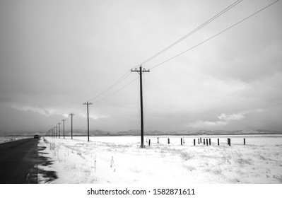 Snow, Power Lines, And Vast Frontier At Rocky Mountain Wildlife Refuge In Black And White