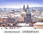 Snow in Prague, rare cold winter conditions. Prague Castle in Czech Republic, snowy weather with trees. City landscape from beautiful town. Winter travelling in white Europe.