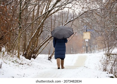 Snow With Rain, Woman With Umbrella Walking In A City Park