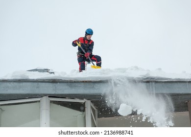 Snow removal from the roof of the building in winter - Powered by Shutterstock